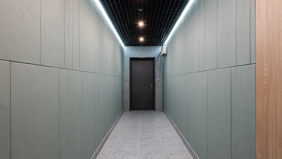 Couloir moderne épuré au long mur éclairé par une lumière douce